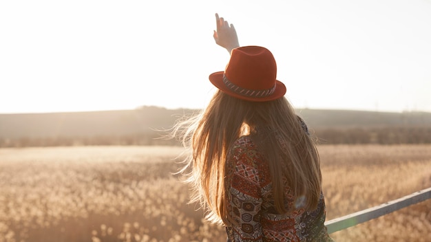 Free photo back view of woman posing in nature