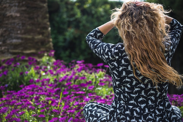 Back view woman sitting in garden