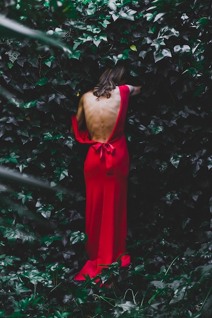 Back view woman stepping into bush