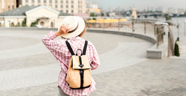 Back view woman traveling with copy space