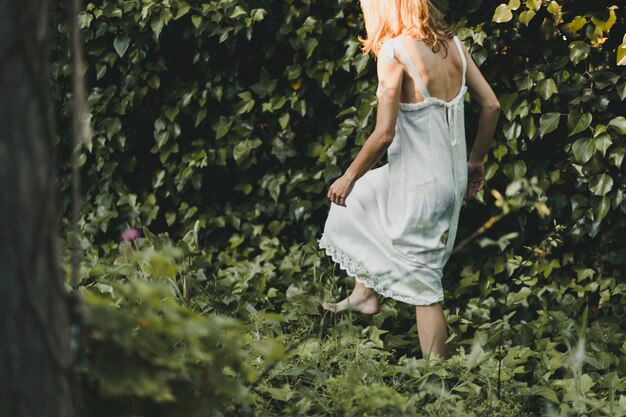 Back view woman walking in garden