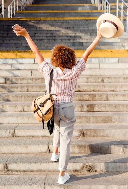 Foto gratuita donna di vista posteriore che cammina le scale all'aperto