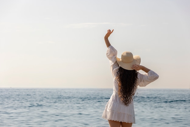 Back view woman wearing hat