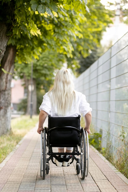 Back view of woman in wheelchair in the city