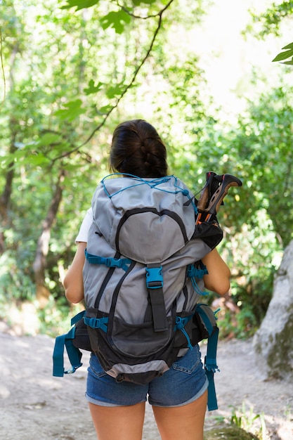 Back view of woman with backpack enjoying nature