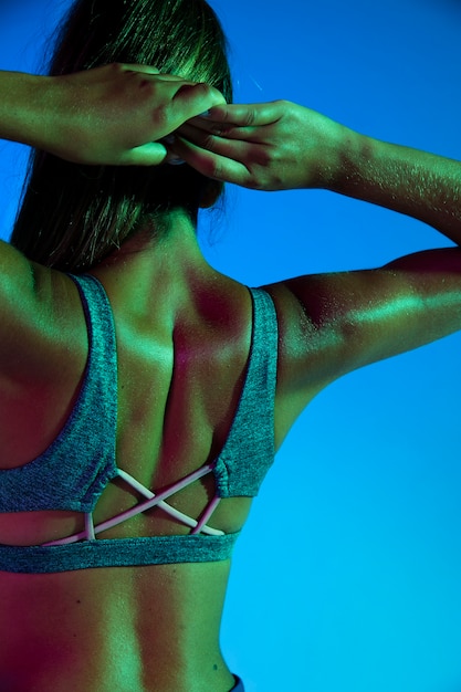 Back view of woman with blue background