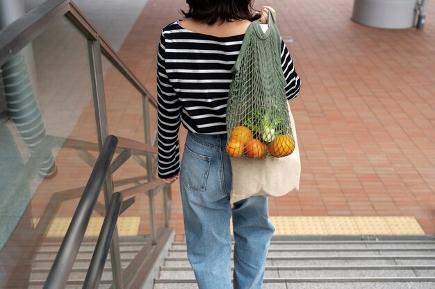 Back view woman with fabric bag