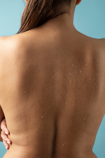 Back view woman with water drops on skin