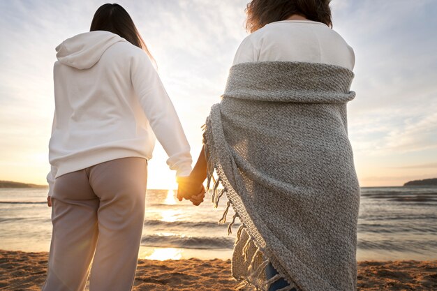 Back view women holding hands