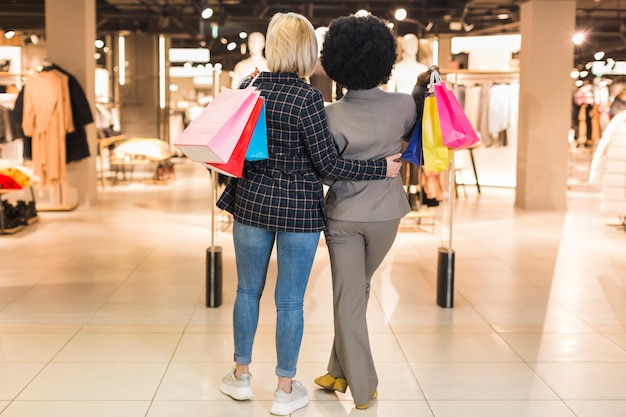 Back view women at the mall together