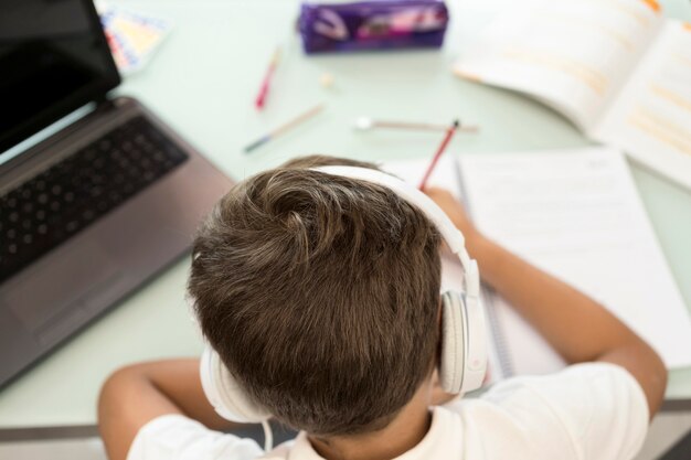 Back view young boy doing his homework