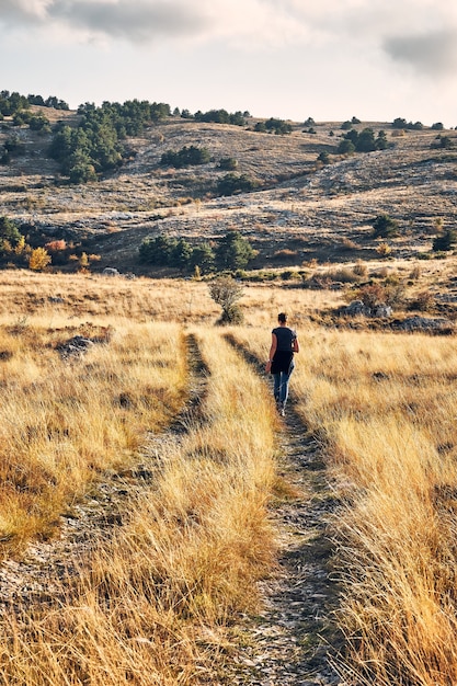 Back view of a young female hiker admiring the view in French Riviera backcountry