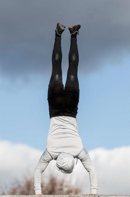 Free photo back view young man doing workout exercises