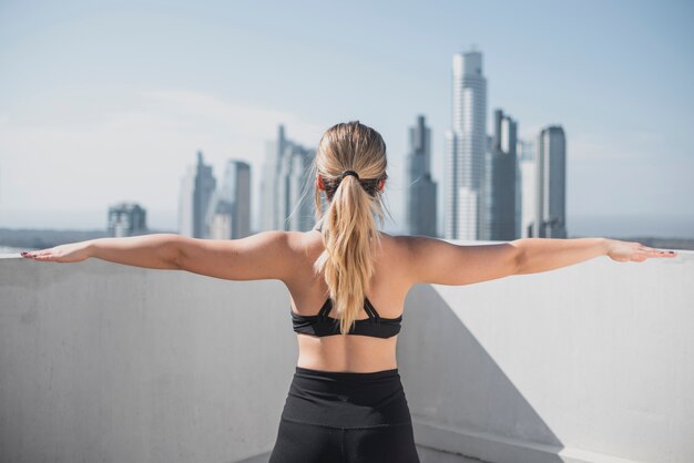 Back view young woman doing sport