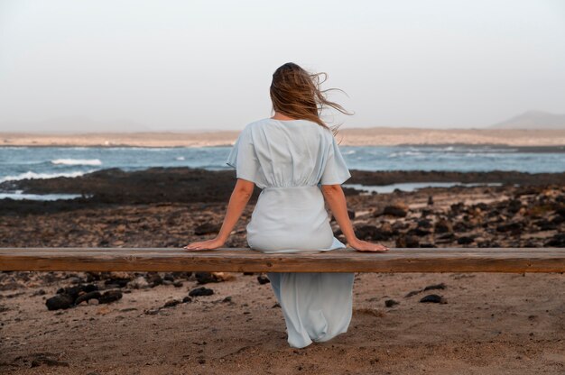 Back view young woman looking at the ocean