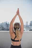 Free photo back view young woman stretching