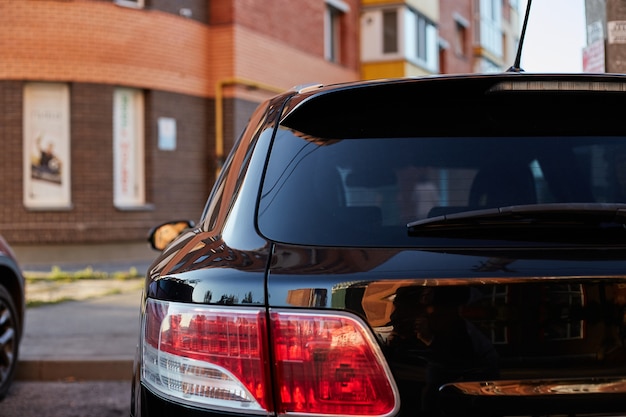 Download Premium Photo | Back window of red car parked on the street in summer sunny day, rear view. mock ...