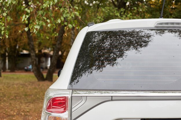 Download Premium Psd Window Decal Mockup On The Back Window Of A White Sedan Car PSD Mockup Templates