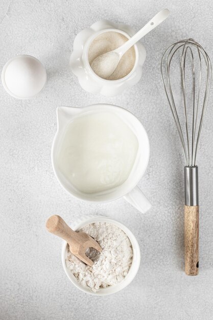 Background for baking cakes and donuts Baking ingredients flour egg milk sugar on a white background Top view