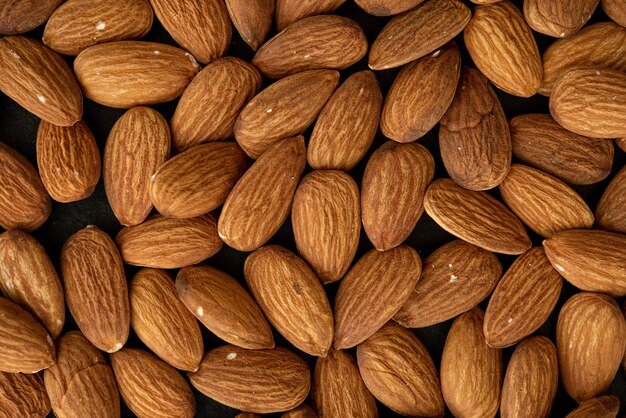 Background of big raw peeled almonds. Top view.