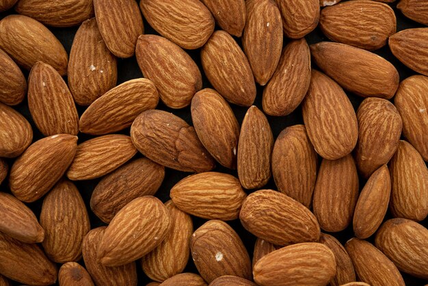 Background of big raw peeled almonds. Top view
