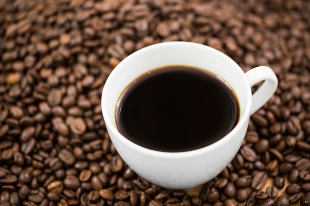 Free photo background of coffee cup on beans