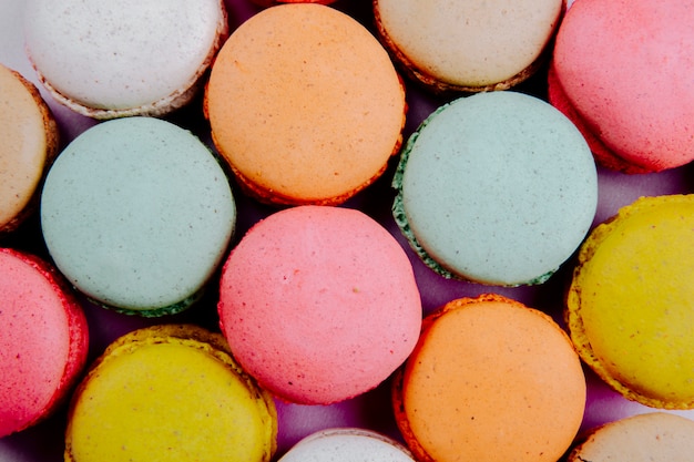 background of colorful delicious macaroons top view