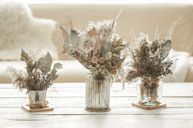 Background composition with many different dried flowers in vases