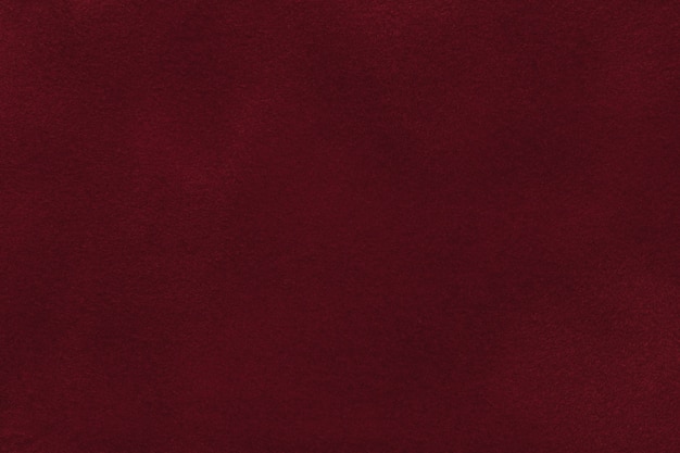 Background of dark red velvet textile, closeup