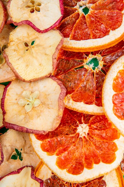 Background of dried fruits apple and orange slices close up view