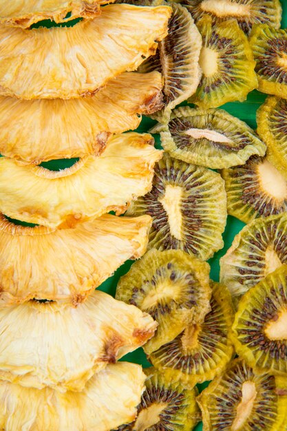 Background of dried fruits pineapple and kiwi slices top view