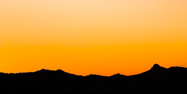 Background from a beautiful colorful sunset with the silhouette of the mountains high quality photo