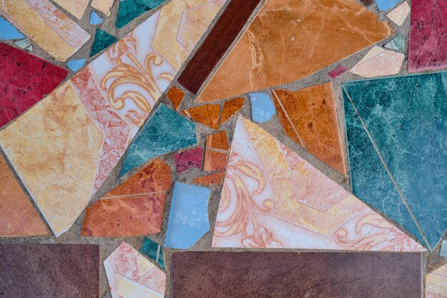 Background from a shard of old mosaic tiles shards of ceramic decorative tiles to create a pattern or background design Idea for decoration of space or wallpaper for advertising