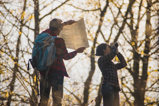 Background of man with map and woman with binoculars