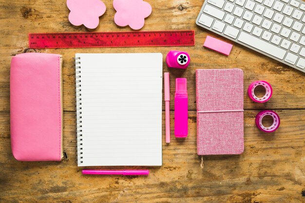 Background of notepad and colorful school supplies