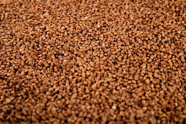 Background of raw uncooked buckwheat side view