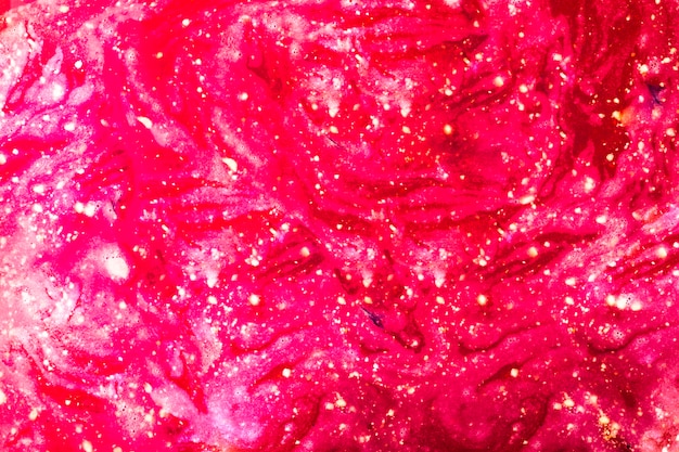 Background of red color bath bomb dissolving in water