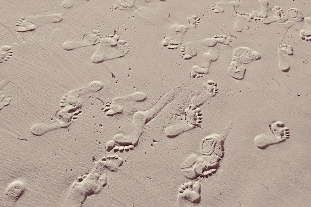 Background of a sandy surface with people footprints