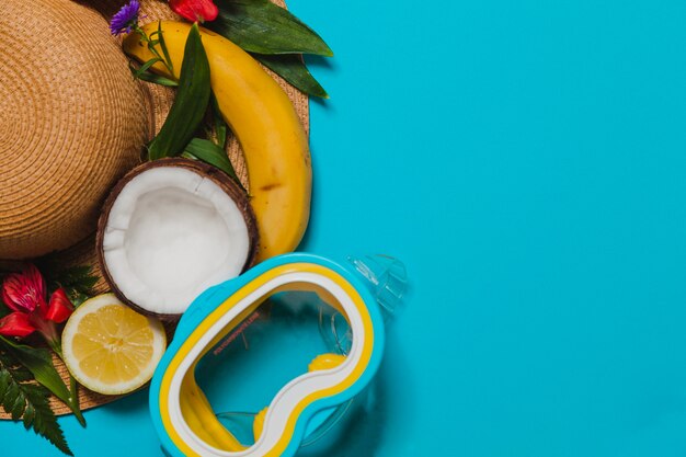 Background of snorkel with hat and fruits