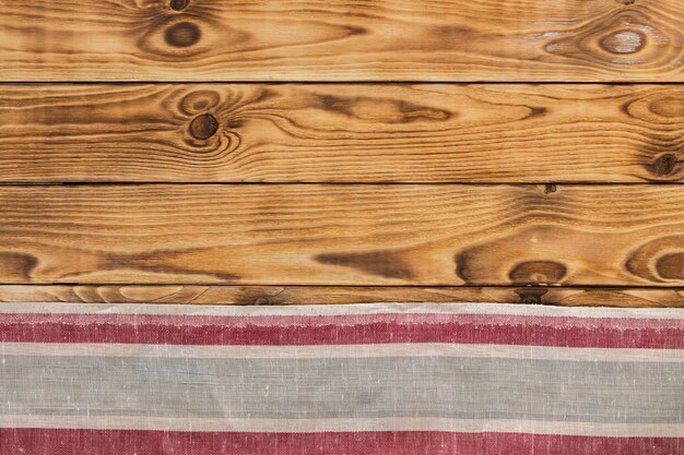 Background with empty wooden table with tablecloth