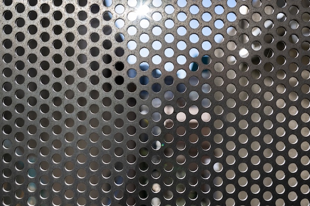 Free photo background with metallic mesh and round holes