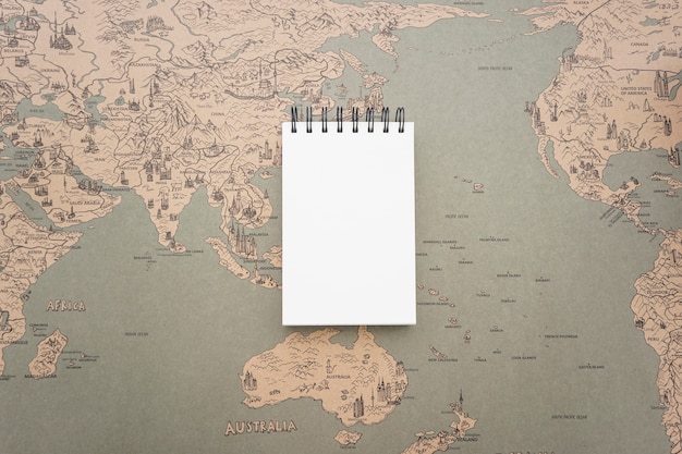 Background with vintage world map and blank notebook