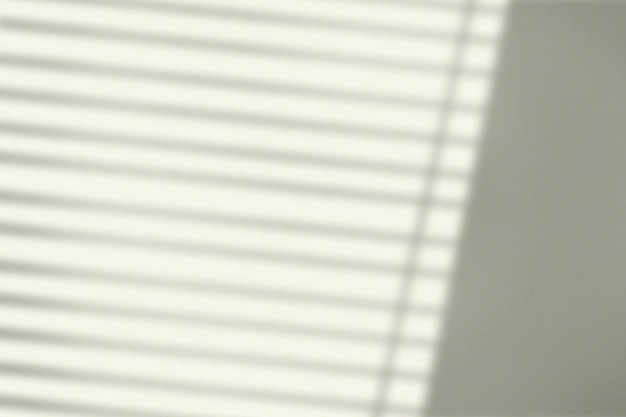 Background with window blinds shadow during golden hour