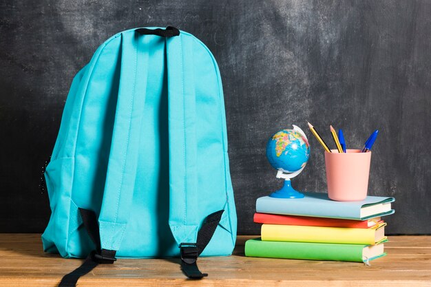 Backpack with books and globe