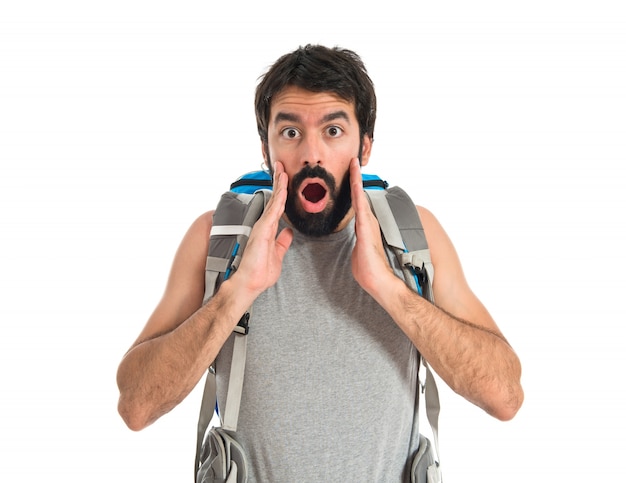 Backpacker doing surprise gesture over white background