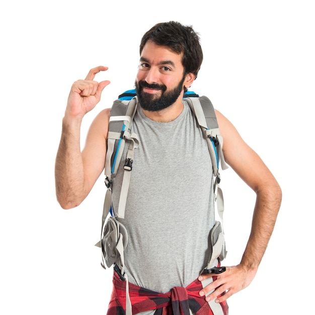 Free photo backpacker doing tiny sign over white background