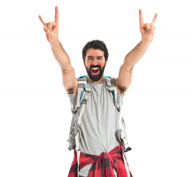 Free photo backpacker making horn gesture over white background