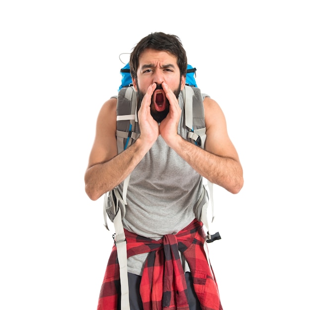 Backpacker shouting over isolated white background