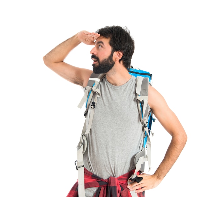 backpacker showing something over white background