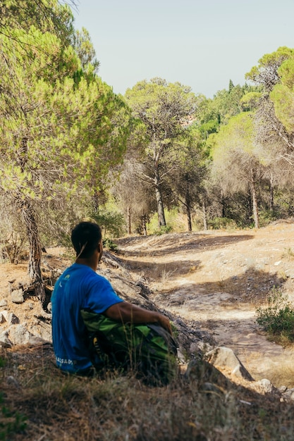 Backpacker sitting in shadows